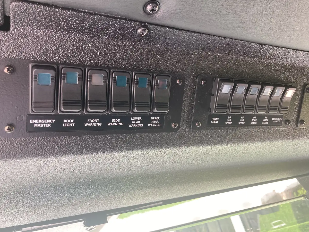 Overhead audio control unit close-up above windshield