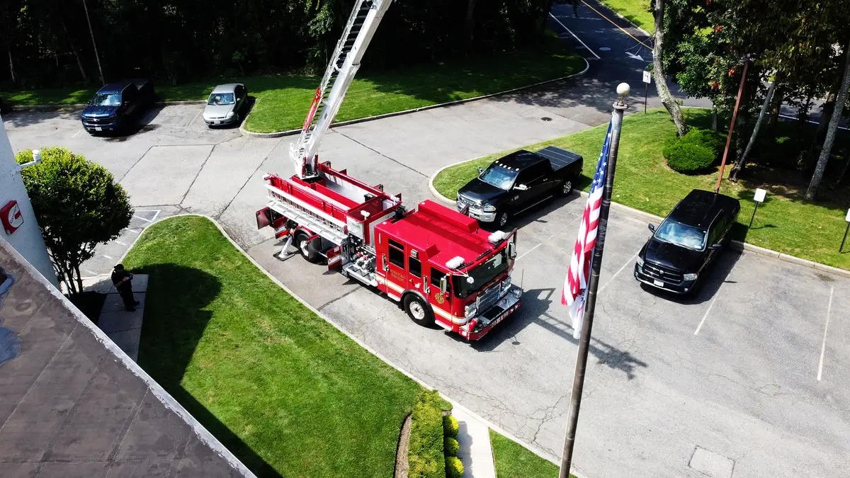 Aerial ladder truck front view showing grille, warning lights, and bumper intakes