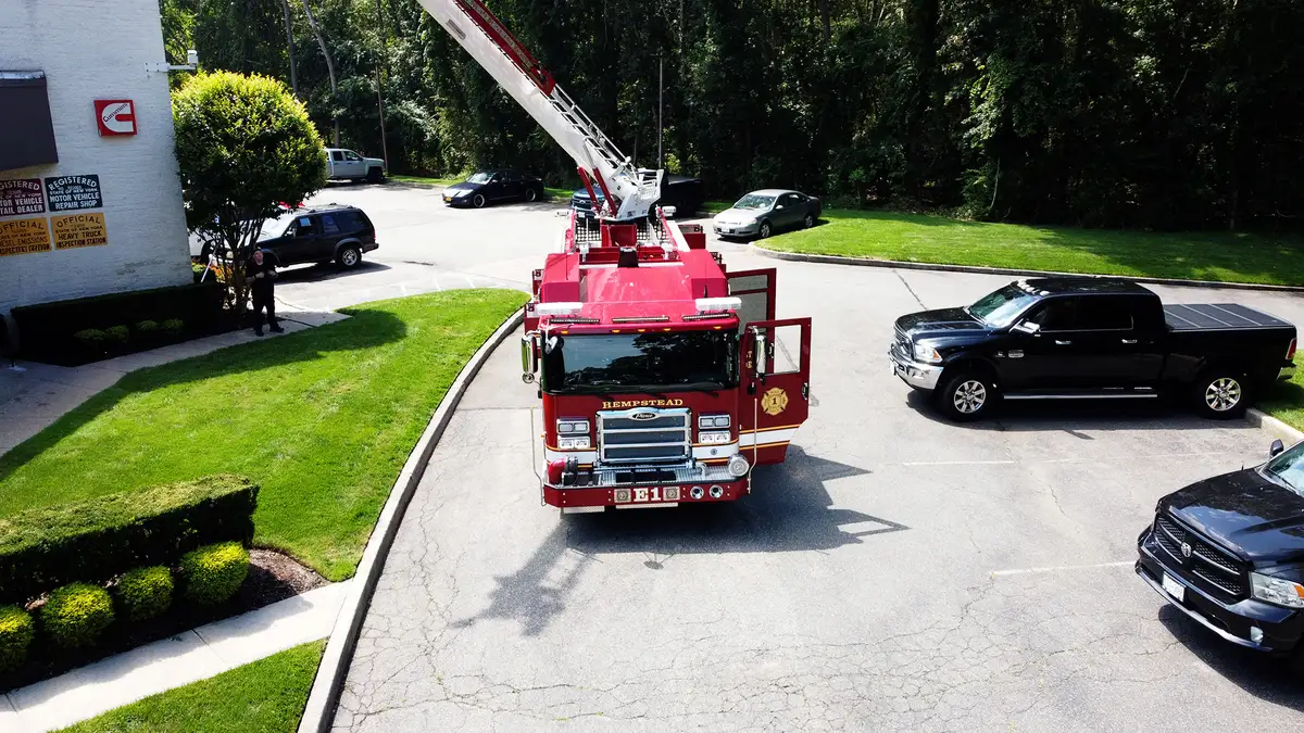 Rear exterior view showing chevron striping, rear access steps, and warning lights