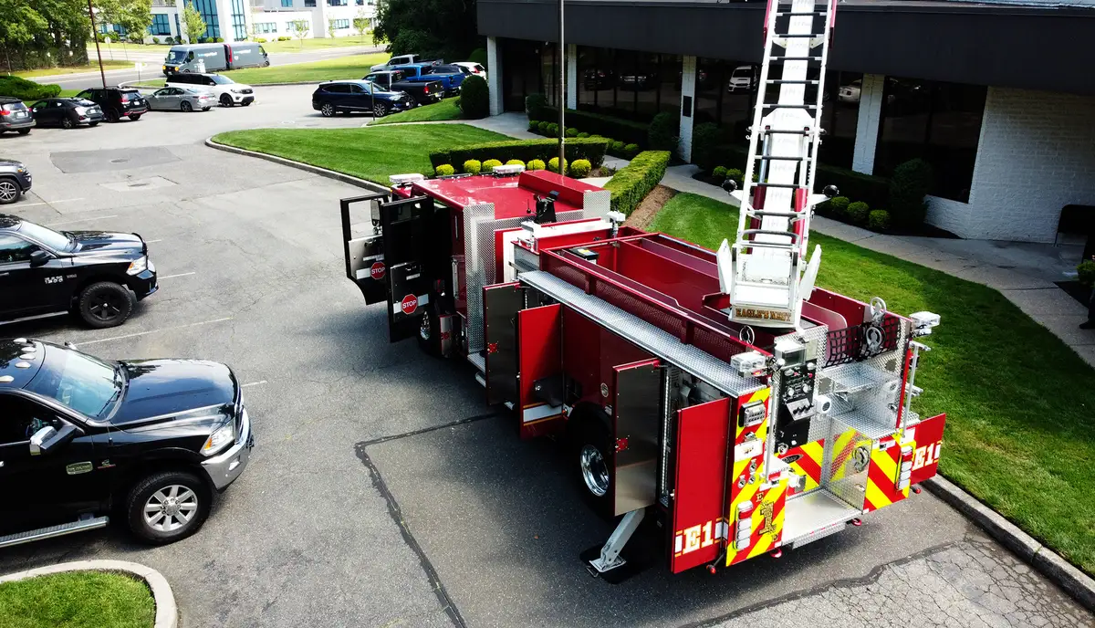 Driver-side mid-body view showing ladder bed supports and side compartment doors