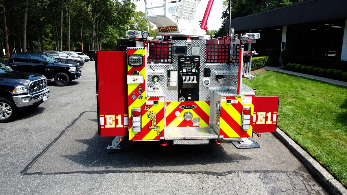 Officer-side mid-body view showing compartment layout and tandem wheel area