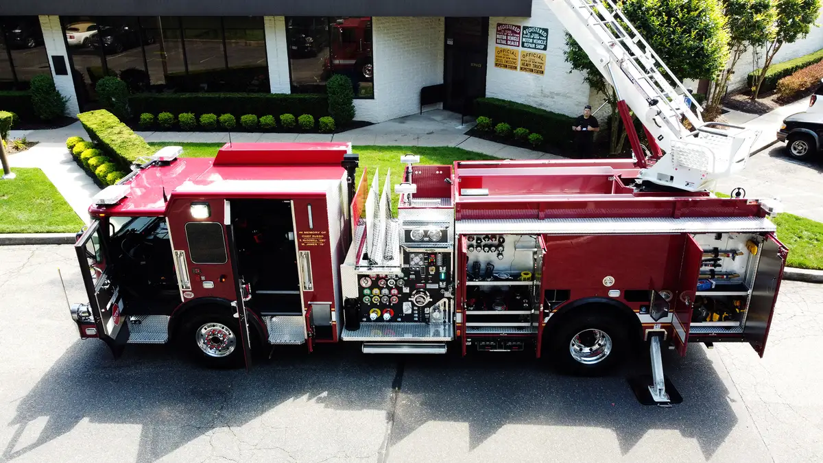 Driver-side profile with open compartments showing shelves and equipment bays