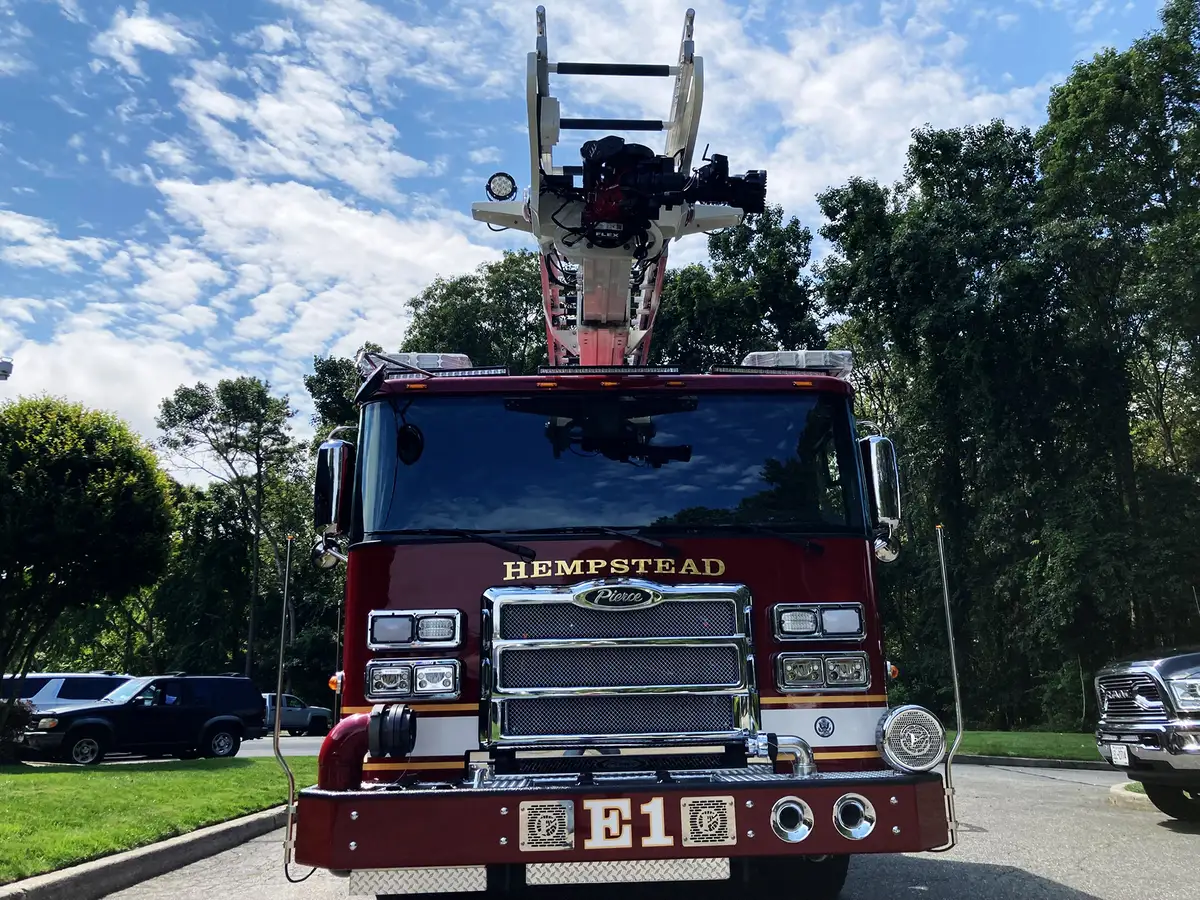 Rear hosebed close-up showing stacked hose bundles and side rails