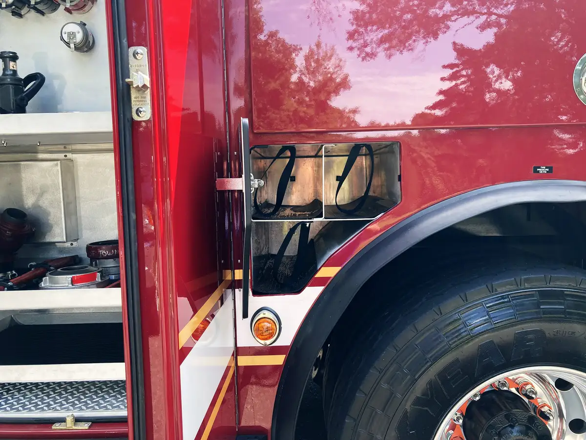 Driver cockpit view showing steering wheel, gauge cluster, and switch panels
