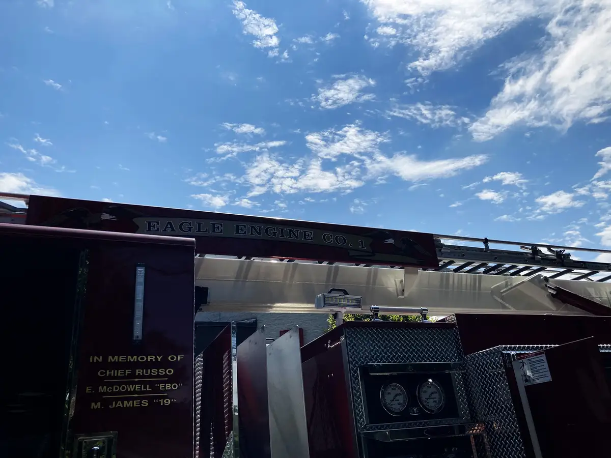 Rear panel detail showing intake caps, valve controls, and chevron background