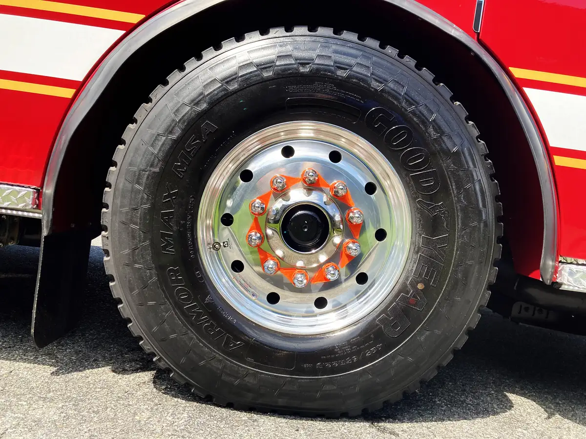 Front-right exterior view showing cab face, bumper, and body side striping