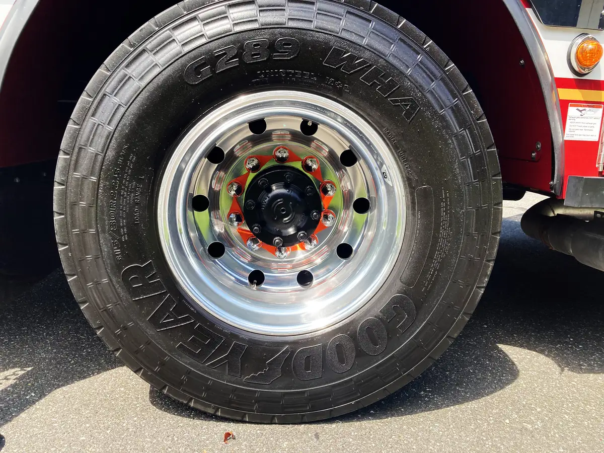 Rear-right exterior view showing chevrons, rear body corner, and wheel area