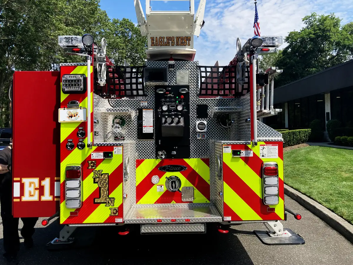 Aerial ladder truck wide side view showing full body profile and ladder sections