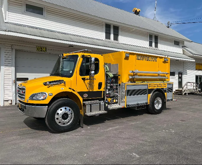 Tanker front-left exterior view showing pump controls and hard suction hose mount