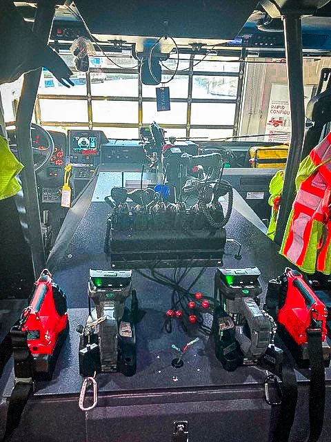 Rear crew interior view showing seat backs, restraints, and center aisle