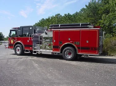 Black-cab pumper driver-side profile showing side body and pump panel area