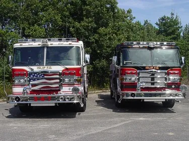Front view of two apparatus showing grilles and warning lights