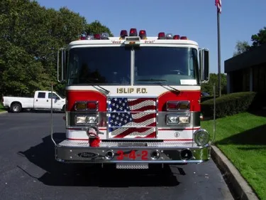 Head-on front view showing grille, bumper inlets, and roof warning lights