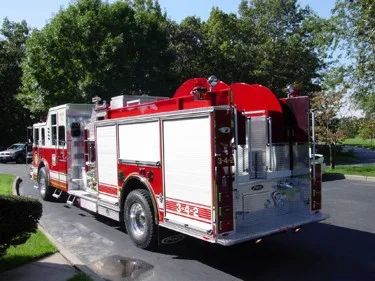 Rear-right exterior view showing side compartments and curved red hosebed cover