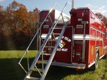 Rear view showing deployed ladder, rear doors, and warning lights