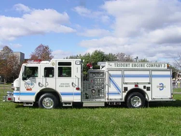 Driver-side full profile showing side pump controls, side compartments, and wheelbase.