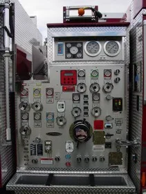 Pump panel close-up showing gauges, valves, and control levers