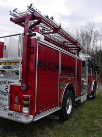 Rear-right exterior view showing side hosebed rails and rear wheel area