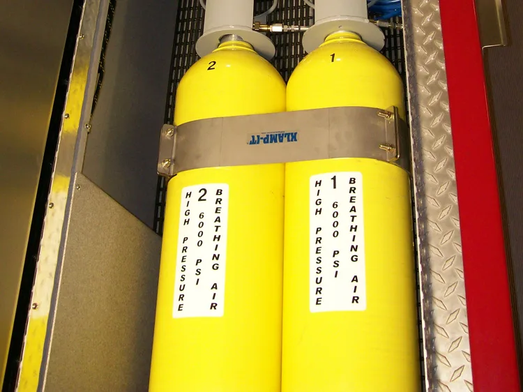 Compartment close-up showing mounted air cylinders in a vertical rack