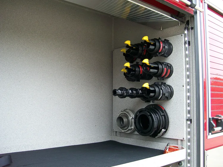 Open side compartment showing port fittings and capped connection points