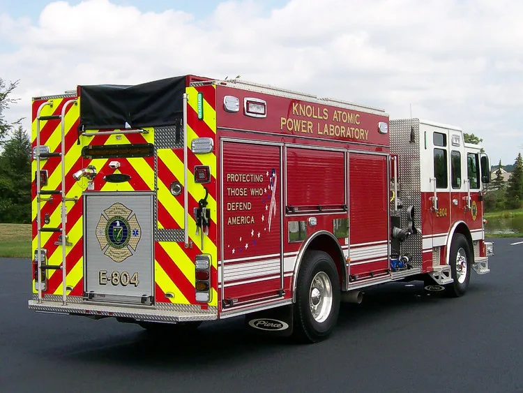 Rear-left exterior view showing chevrons, rear body, and side compartments