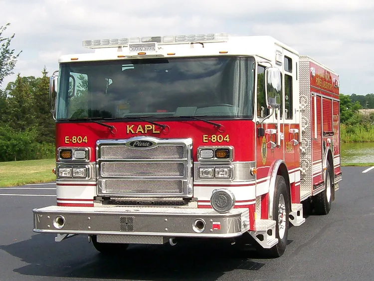 Head-on front view showing grille, bumper, and warning light bar