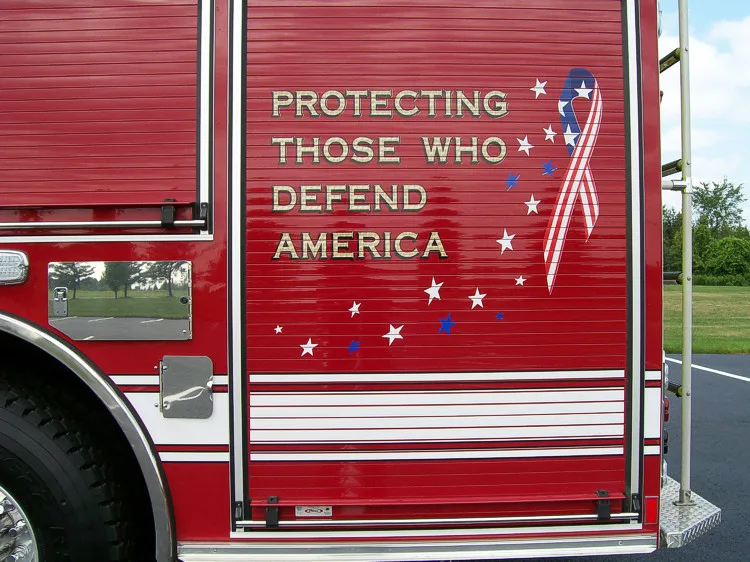 Body side close-up showing patriotic lettering on compartment door