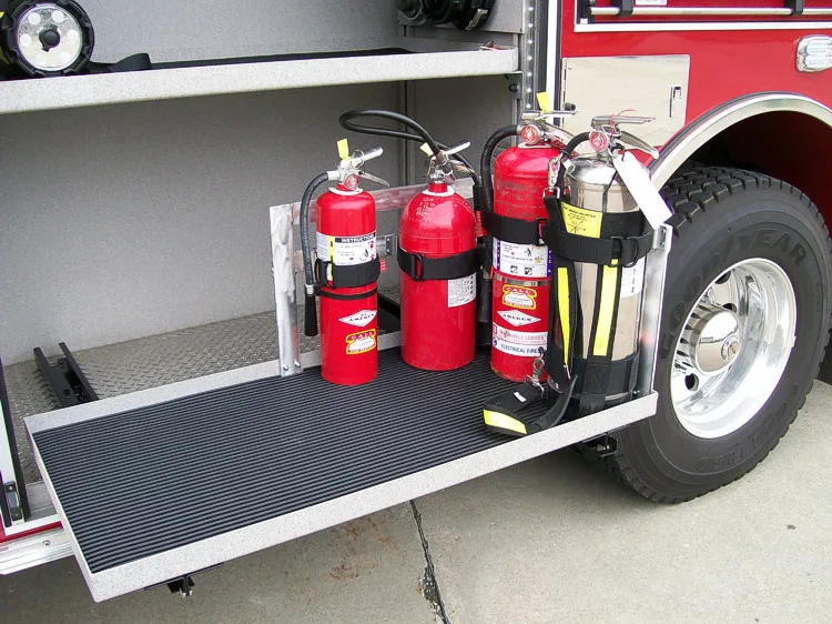 Open lower compartment showing mounted extinguishers on a slide-out tray
