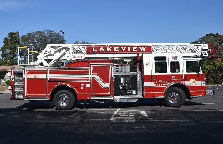 Passenger-side full profile showing aerial ladder, side compartments, and wheel layout