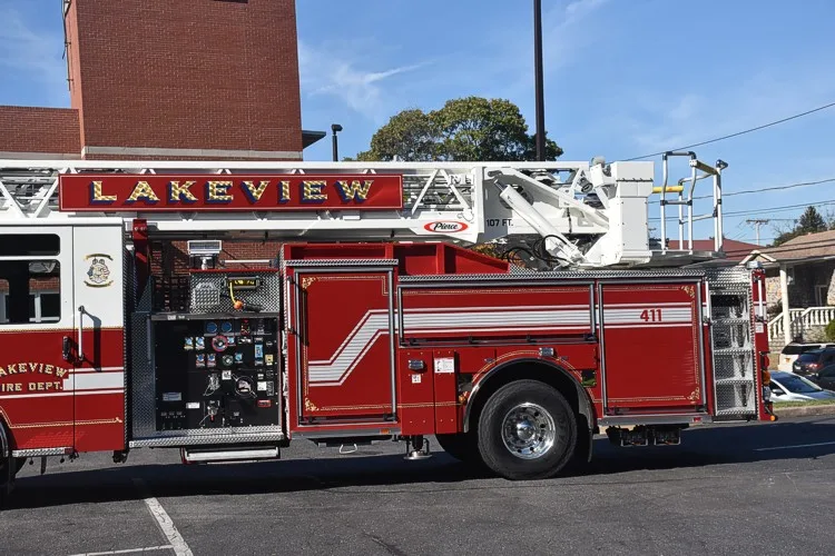 Mid-body passenger-side close-up showing pump panel controls and compartment doors