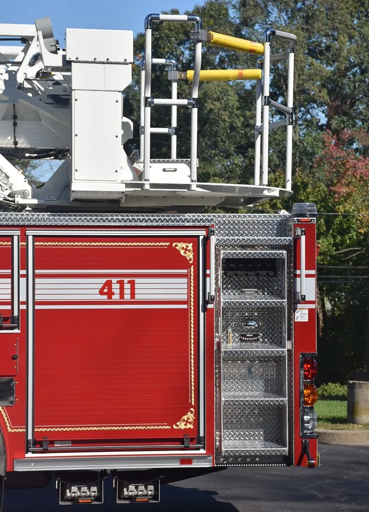 Rear body close-up showing ladder access platform and rear compartment stack