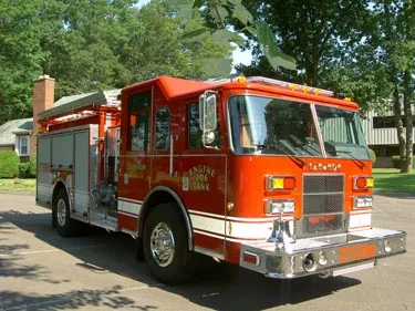 Front right exterior angle showing grille, bumper, windshield, and right-side compartment body.