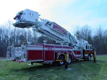 Rear-right exterior view showing raised ladder sections and rear body compartments