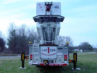 Direct rear view showing ladder base, rear body doors, and outrigger pads