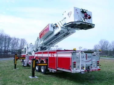 Rear-right exterior view showing elevated bucket and rear compartment layout