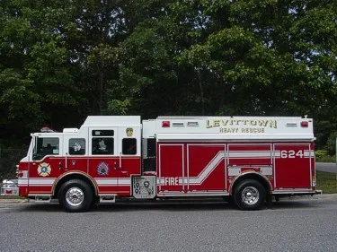 Passenger-side full profile showing heavy rescue body and compartment layout