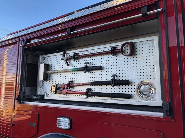 Open side compartment showing mounted hand tools in horizontal rack