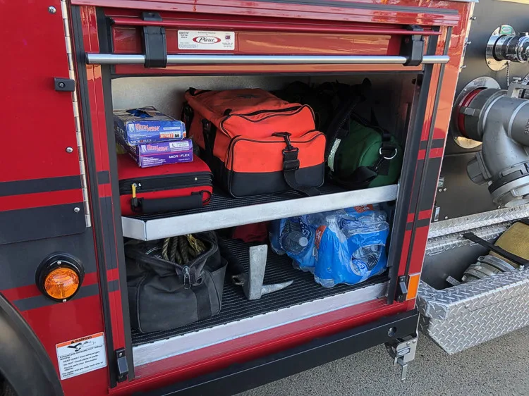 Open side compartment showing bags and gear organized on shelves
