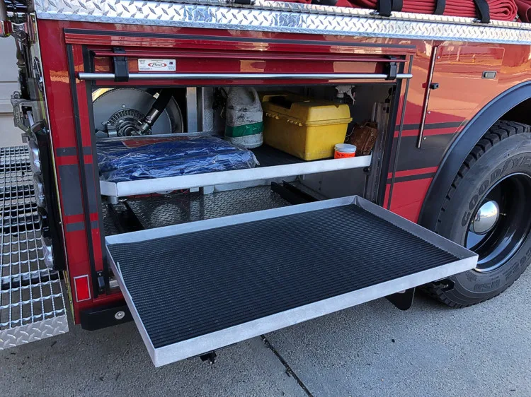 Open lower side compartment with pull-out tray showing tool storage