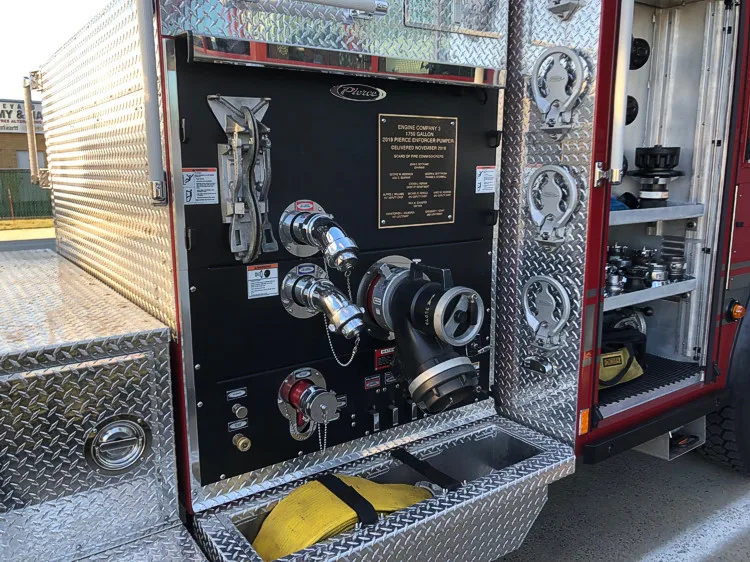 Pump panel close-up showing labeled gauges, controls, and intake connections