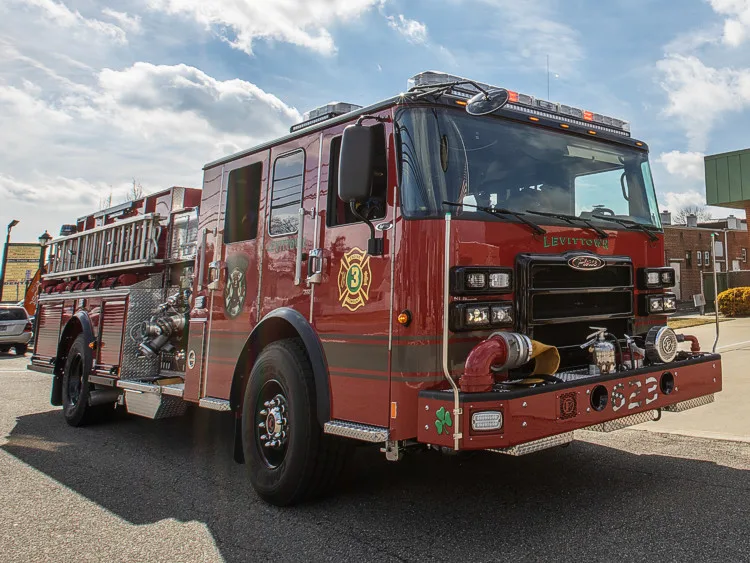 Pumper front-left exterior view showing cab and side body parked outside