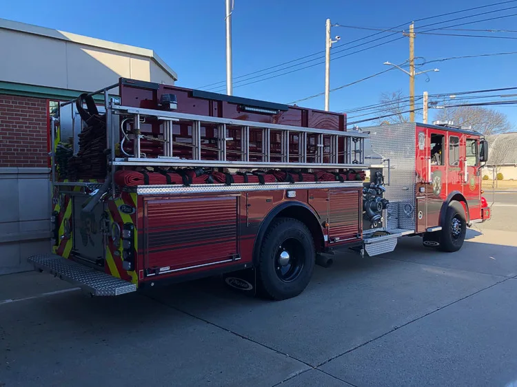 Driver-side full profile view showing pumper body and wheelbase
