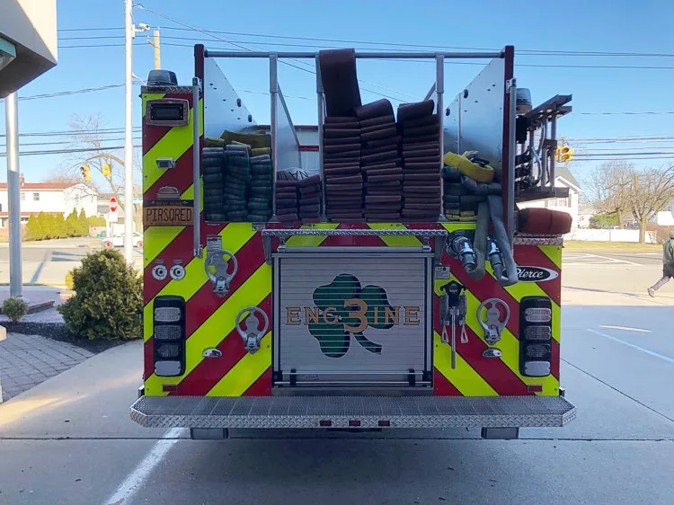 Rear view showing red-and-yellow chevrons and upper rear hosebed area