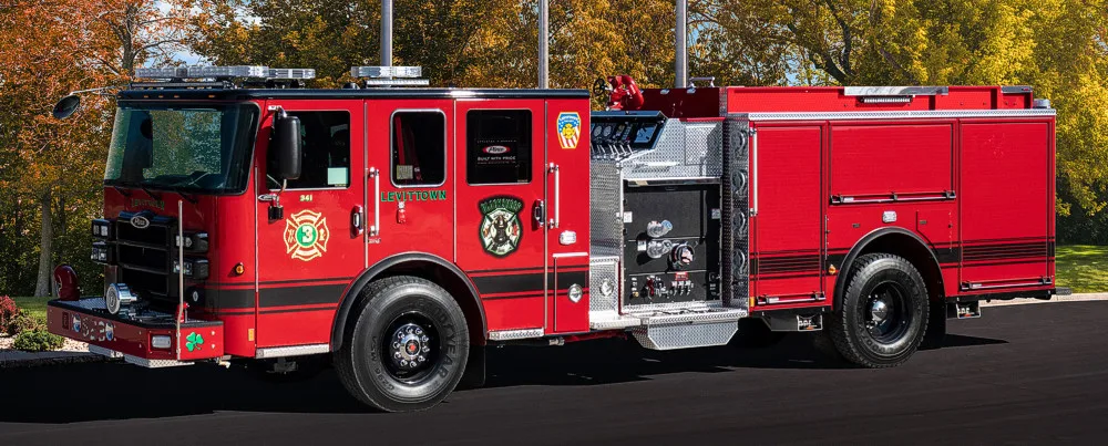 Pumper driver-side profile view showing full body and side compartments