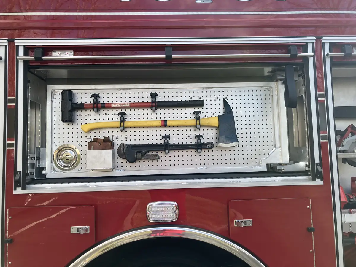 Driver cockpit close-up showing steering wheel, gauges, and dash controls