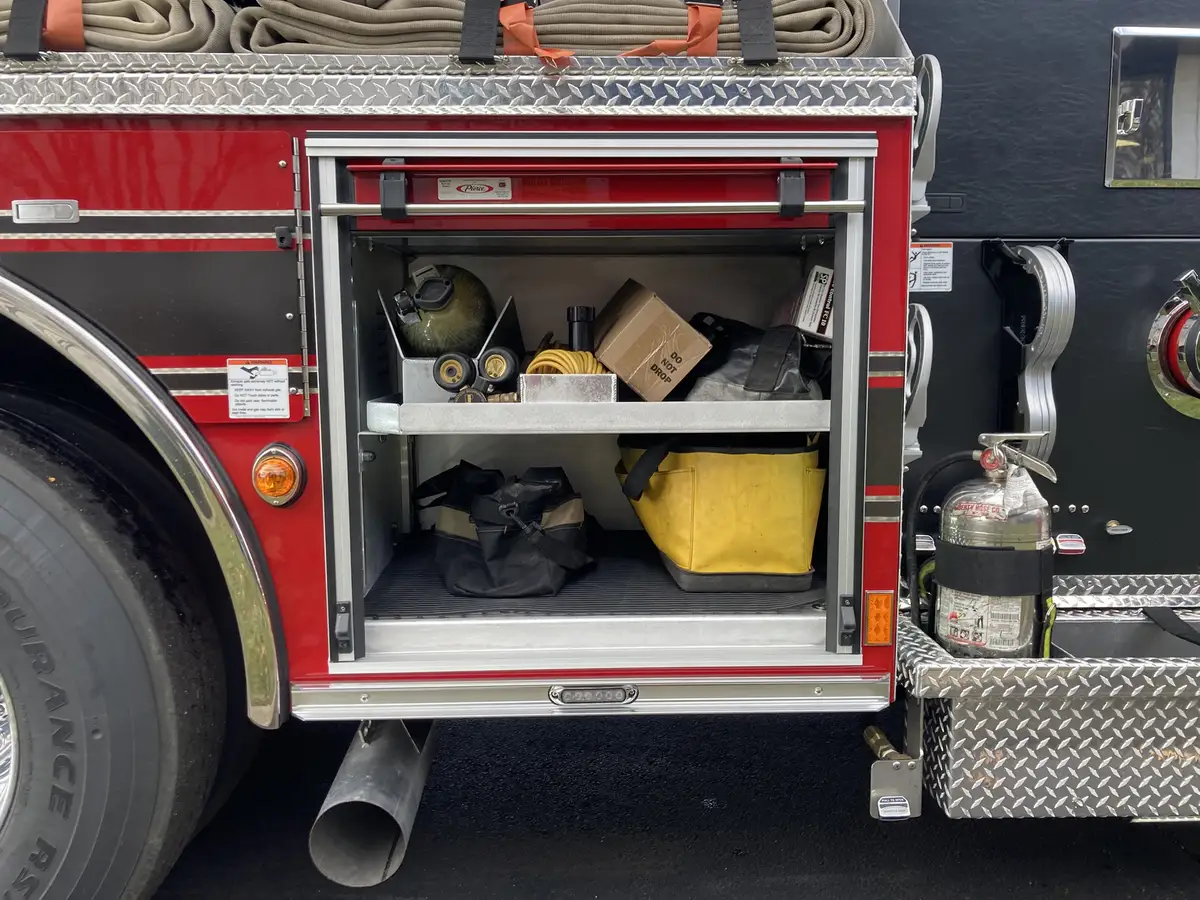 Rear body corner detail showing warning lights and chevron striping