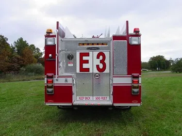 Rear view showing rear door panel, warning lights, and hosebed area