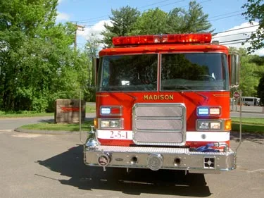 Front exterior view showing grille, bumper, and warning lights