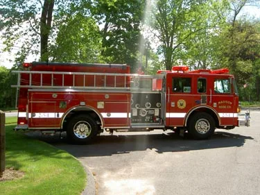 Driver-side profile view showing pump panel area and side hosebed