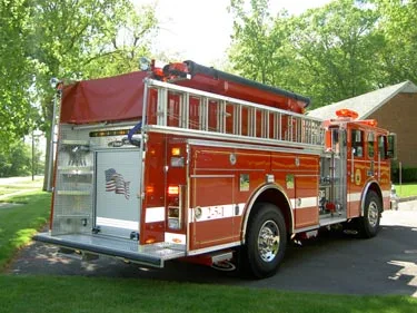 Rear-left exterior view showing side hosebed rails and rear body panel